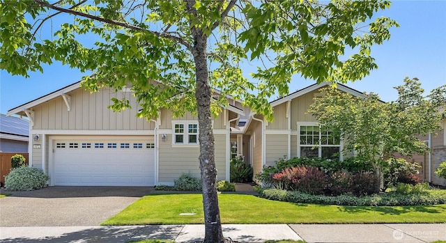 4972 Spokane St NE, Lacey, WA 98516 - view of front of home featuring asphalt driveway, a garage, a front lawn, and board and batten siding