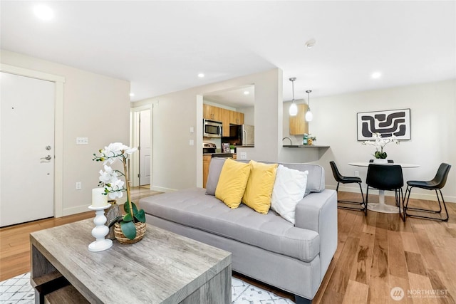 15155 NE 82nd St Unit 103, Redmond, WA 98052 - living area featuring light wood-type flooring, recessed lighting, and baseboards