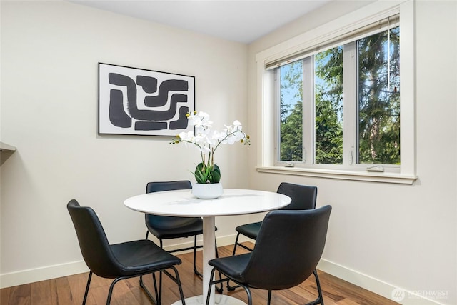 15155 NE 82nd St Unit 103, Redmond, WA 98052 - dining room with baseboards and wood finished floors