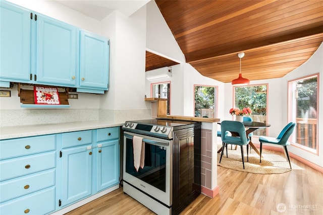 7141 47th Ave SW, Seattle, WA 98136 - kitchen featuring stainless steel range with electric cooktop, blue cabinetry, light countertops, light wood-type flooring, and vaulted ceiling