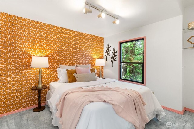 7141 47th Ave SW, Seattle, WA 98136 - bedroom with wallpapered walls, track lighting, an accent wall, carpet flooring, and baseboards