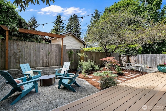 7141 47th Ave SW, Seattle, WA 98136 - wooden terrace featuring an outdoor fire pit and a fenced backyard