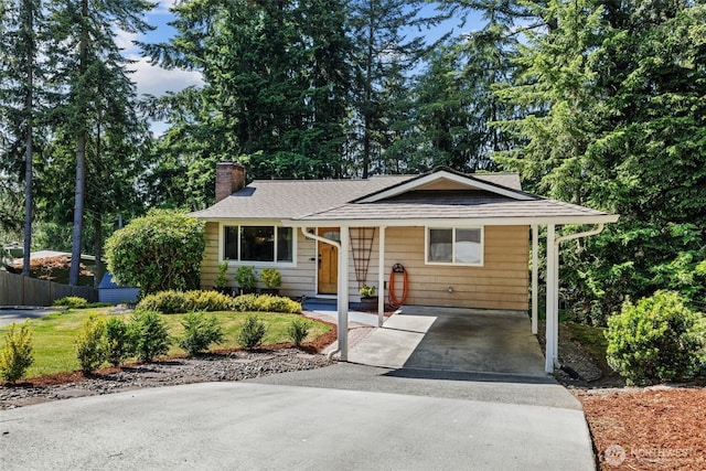 5629 146th St SW, Edmonds, WA 98026 - view of front of property with a chimney, concrete driveway, a shingled roof, and a carport