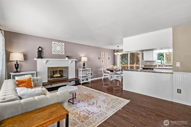 5629 146th St SW, Edmonds, WA 98026 - living area featuring dark wood finished floors, a fireplace, and a chandelier
