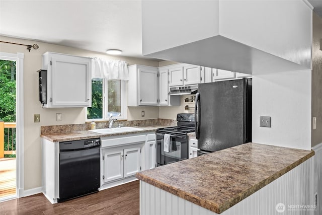 5629 146th St SW, Edmonds, WA 98026 - kitchen with black appliances, a sink, under cabinet range hood, a peninsula, and white cabinets