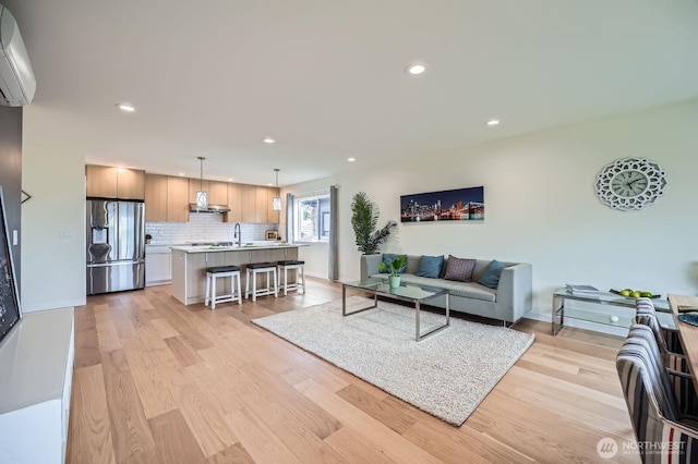 5930 18th Ave S, Seattle, WA 98108 - living area with a wall mounted AC, light wood-type flooring, recessed lighting, and baseboards