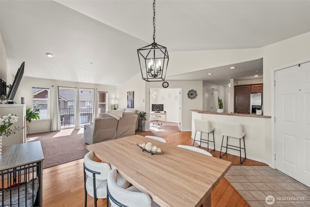 2143 Hammond Ave Unit E10, Dupont, WA 98327 - dining area featuring lofted ceiling, a chandelier, and light wood finished floors