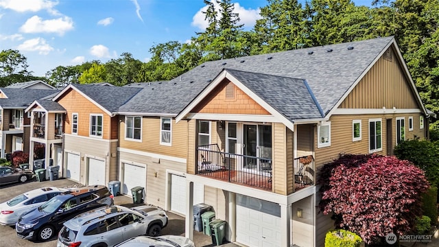 2143 Hammond Ave Unit E10, Dupont, WA 98327 - view of front of house with a garage, roof with shingles, board and batten siding, and driveway