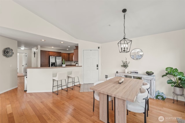 2143 Hammond Ave Unit E10, Dupont, WA 98327 - dining room featuring light wood-style flooring, a chandelier, vaulted ceiling, recessed lighting, and baseboards