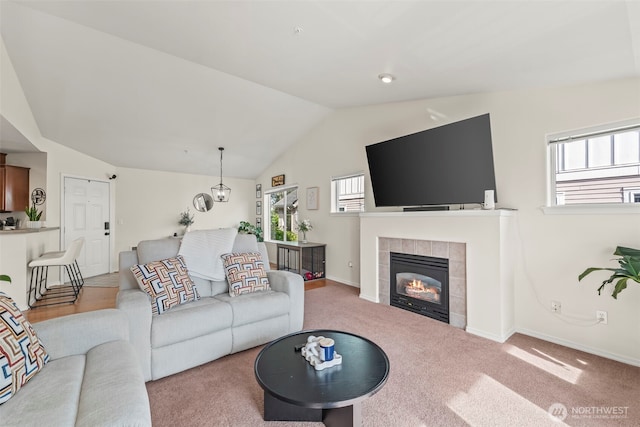 2143 Hammond Ave Unit E10, Dupont, WA 98327 - living area with vaulted ceiling, a fireplace, baseboards, and carpet flooring