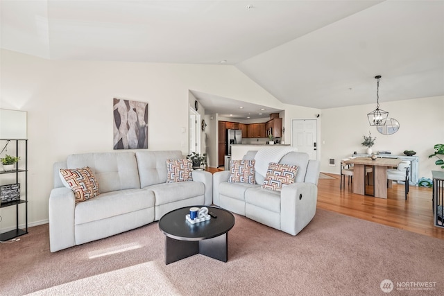 2143 Hammond Ave Unit E10, Dupont, WA 98327 - living area with carpet floors, vaulted ceiling, a chandelier, and baseboards