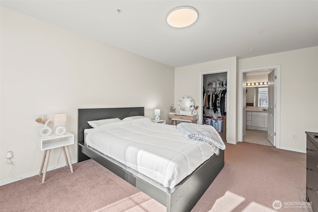 2143 Hammond Ave Unit E10, Dupont, WA 98327 - bedroom with carpet, a walk in closet, baseboards, ensuite bathroom, and a closet