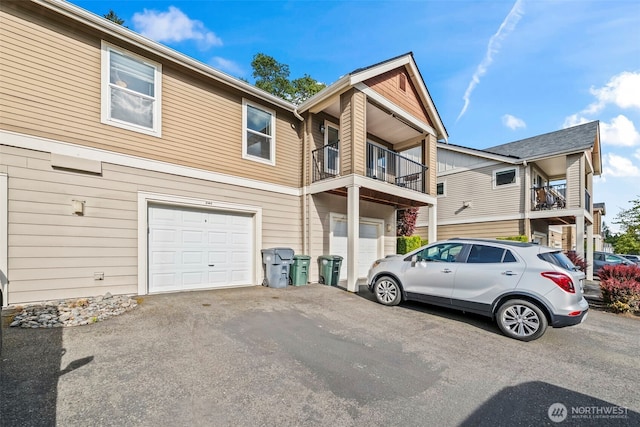 2143 Hammond Ave Unit E10, Dupont, WA 98327 - multi unit property featuring an attached garage, asphalt driveway, and a balcony