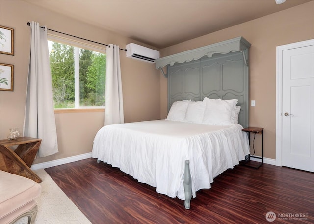 2674 Lost Mountain Rd, Sequim, WA 98382 - bedroom with a wall mounted AC, dark wood-type flooring, and baseboards