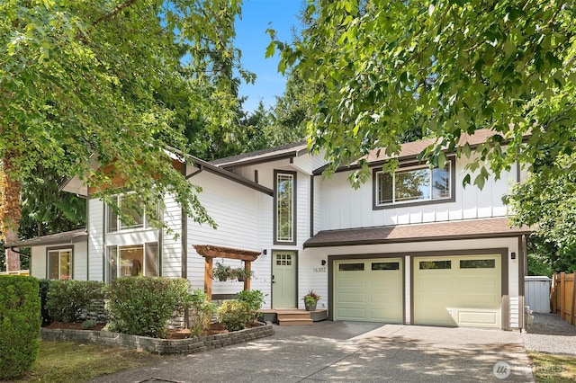 16302 NE 104th St, Redmond, WA 98052 - view of front of property featuring driveway, an attached garage, and board and batten siding