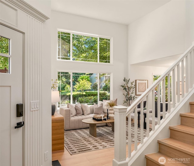 16302 NE 104th St, Redmond, WA 98052 - living area featuring stairs, a high ceiling, and wood finished floors