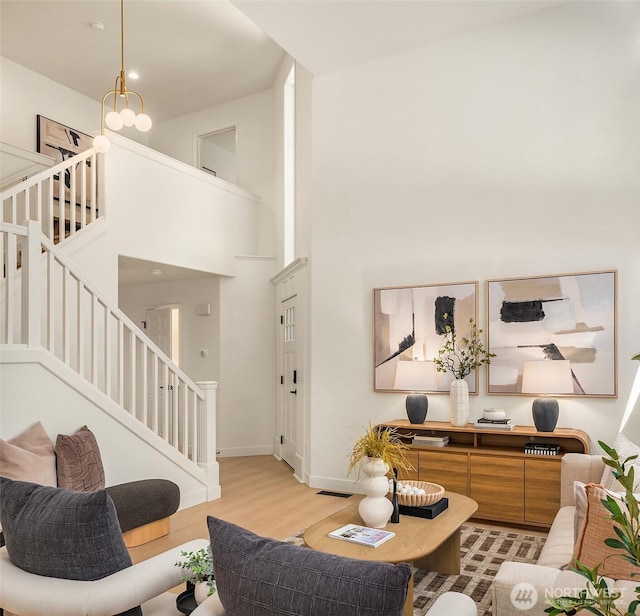 16302 NE 104th St, Redmond, WA 98052 - living room with a high ceiling, stairs, wood finished floors, and baseboards