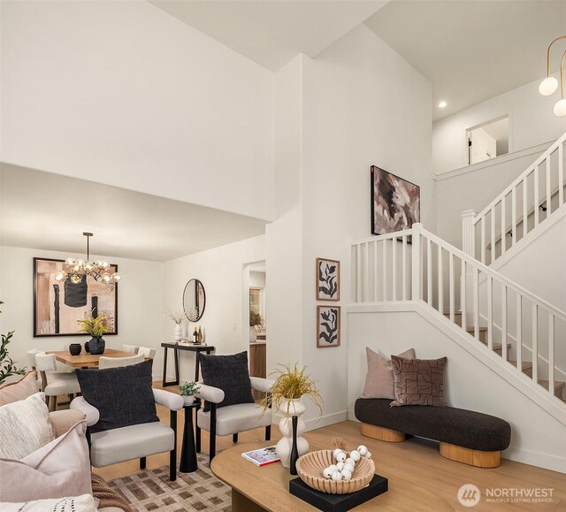 16302 NE 104th St, Redmond, WA 98052 - living area featuring stairs, wood finished floors, a chandelier, a towering ceiling, and baseboards