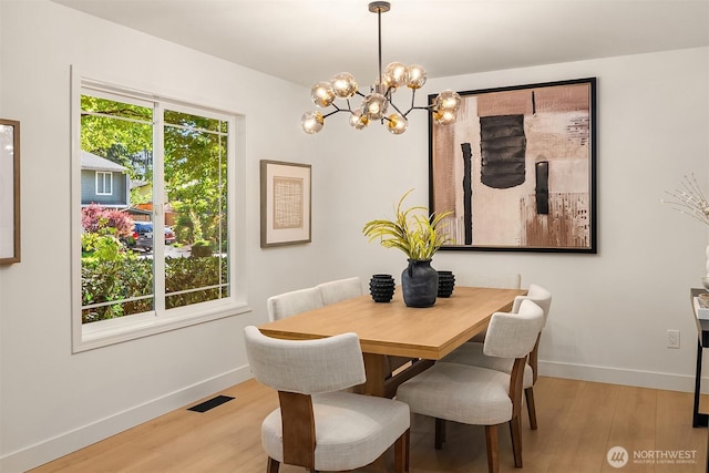 16302 NE 104th St, Redmond, WA 98052 - dining room featuring a chandelier, light wood-type flooring, and baseboards