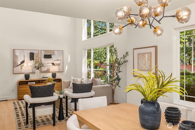 16302 NE 104th St, Redmond, WA 98052 - dining area featuring light wood finished floors, a chandelier, and a towering ceiling