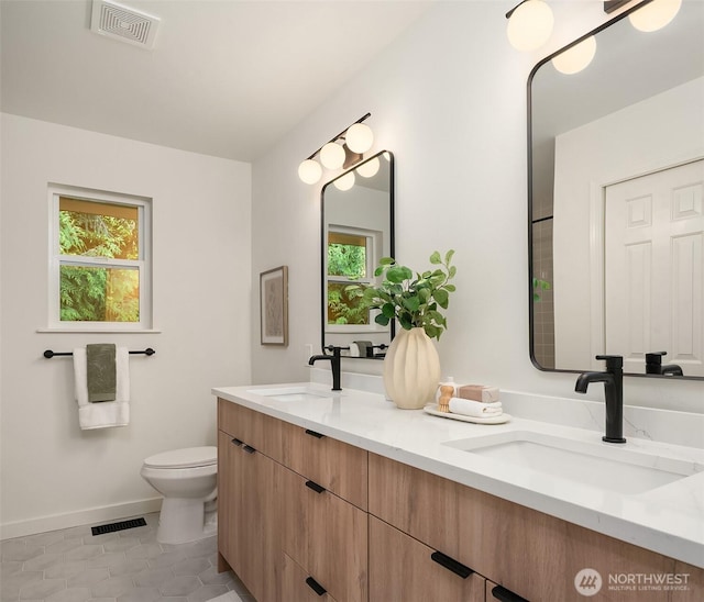 16302 NE 104th St, Redmond, WA 98052 - full bathroom with double vanity, toilet, tile patterned floors, and baseboards