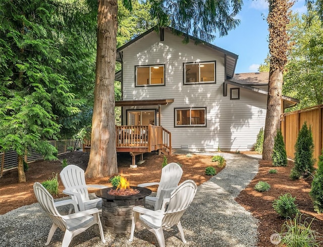 16302 NE 104th St, Redmond, WA 98052 - back of property featuring a wooden deck, a fenced backyard, and a fire pit