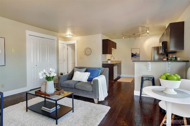 120 NW 39th St Unit 406, Seattle, WA 98107 - living room featuring dark wood-type flooring and baseboards