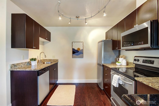 120 NW 39th St Unit 406, Seattle, WA 98107 - kitchen featuring stainless steel appliances, a sink, baseboards, and light stone counters