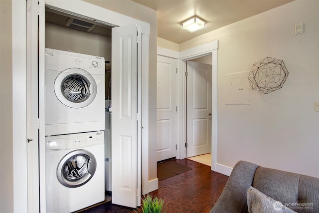 120 NW 39th St Unit 406, Seattle, WA 98107 - laundry area with stacked washer / dryer, dark wood finished floors, baseboards, and electric panel