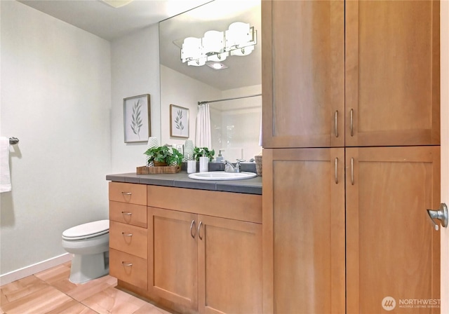 16141 Cleveland St Unit 611, Redmond, WA 98052 - bathroom featuring vanity, toilet, baseboards, and a shower with shower curtain