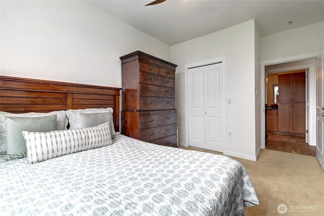 16141 Cleveland St Unit 611, Redmond, WA 98052 - bedroom featuring light carpet, a closet, baseboards, and a ceiling fan