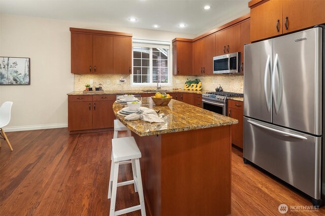 15606 Country Club Dr Unit B, Bothell, WA 98012 - kitchen with appliances with stainless steel finishes, dark wood-type flooring, tasteful backsplash, a sink, and recessed lighting