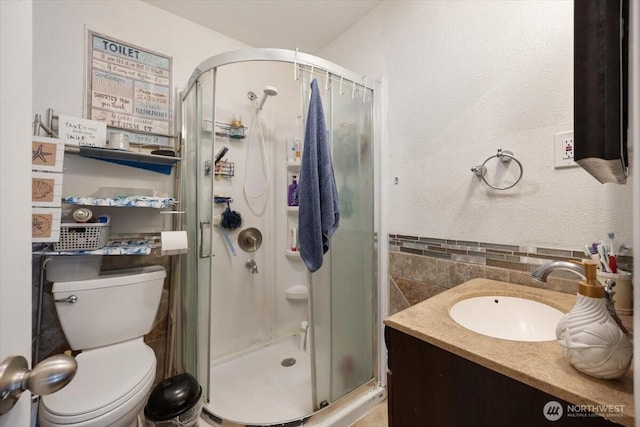 412 Maple Ct, Toppenish, WA 98948 - full bath featuring tile walls, a shower stall, toilet, and vanity