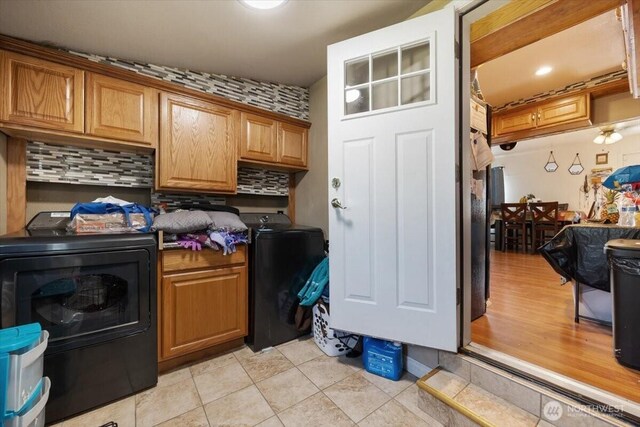 412 Maple Ct, Toppenish, WA 98948 - washroom featuring cabinet space, washing machine and dryer, and light tile patterned floors