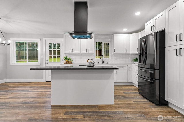 3107 34th Street Ct E, Tacoma, WA 98443 - kitchen with refrigerator with ice dispenser, island exhaust hood, backsplash, white cabinetry, and baseboards