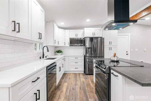 3107 34th Street Ct E, Tacoma, WA 98443 - kitchen featuring appliances with stainless steel finishes, island exhaust hood, a sink, backsplash, and wood finished floors