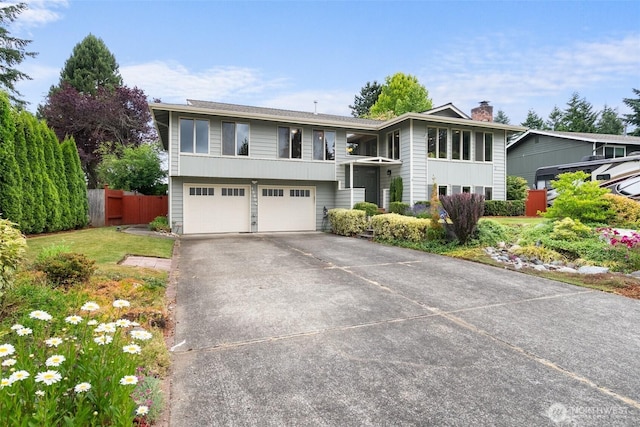 13304 SE 248th Pl, Kent, WA 98042 - bi-level home with an attached garage, concrete driveway, and a chimney