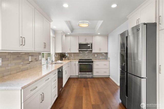 13304 SE 248th Pl, Kent, WA 98042 - kitchen featuring stainless steel appliances, white cabinetry, a raised ceiling, light stone counters, and tasteful backsplash