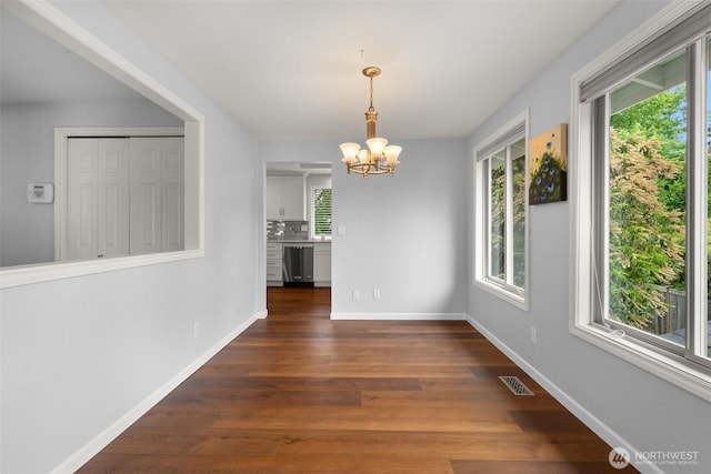 13304 SE 248th Pl, Kent, WA 98042 - unfurnished dining area with a chandelier, dark wood finished floors, and healthy amount of natural light