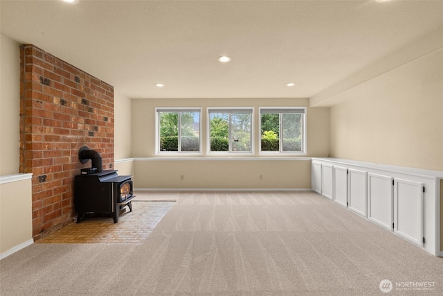 13304 SE 248th Pl, Kent, WA 98042 - unfurnished living room featuring healthy amount of natural light, light carpet, a wood stove, and recessed lighting
