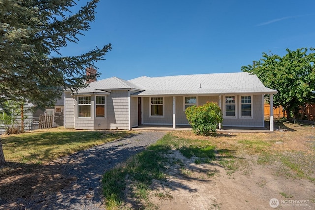 614 E Main Ave, Soap Lake, WA 98851 - single story home featuring a chimney, covered porch, and gravel driveway
