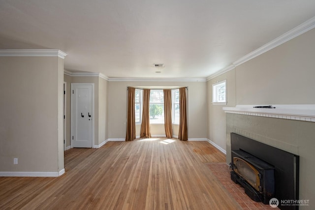 614 E Main Ave, Soap Lake, WA 98851 - unfurnished living room with wood finished floors, baseboards, a wood stove, and ornamental molding