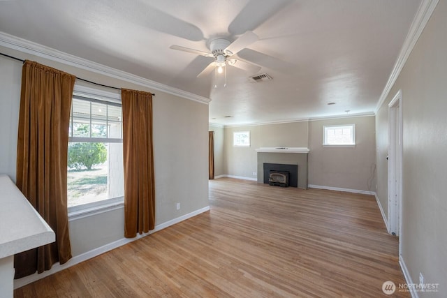 614 E Main Ave, Soap Lake, WA 98851 - unfurnished living room with crown molding, ceiling fan, light wood-style flooring, a fireplace with flush hearth, and baseboards