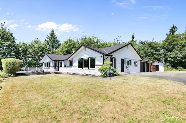 3827 90th Ave E, Edgewood, WA 98371 - single story home featuring a front yard, asphalt driveway, an attached garage, and an outdoor structure