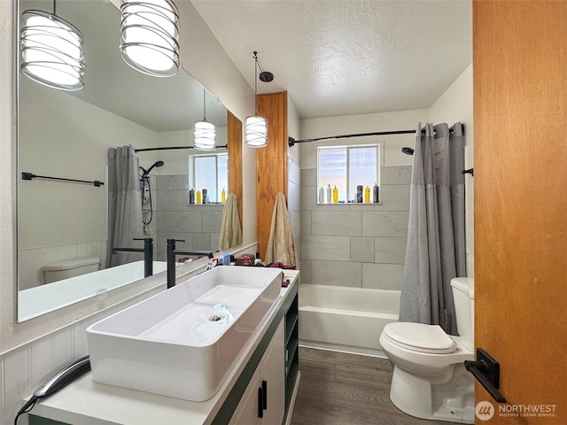81 Robbins Rd, Sequim, WA 98382 - full bath with toilet, vanity, shower / tub combo with curtain, wood finished floors, and a textured ceiling