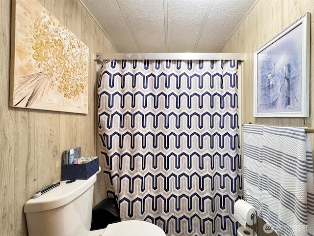 81 Robbins Rd, Sequim, WA 98382 - full bath featuring a textured ceiling, toilet, a shower with curtain, and wood walls