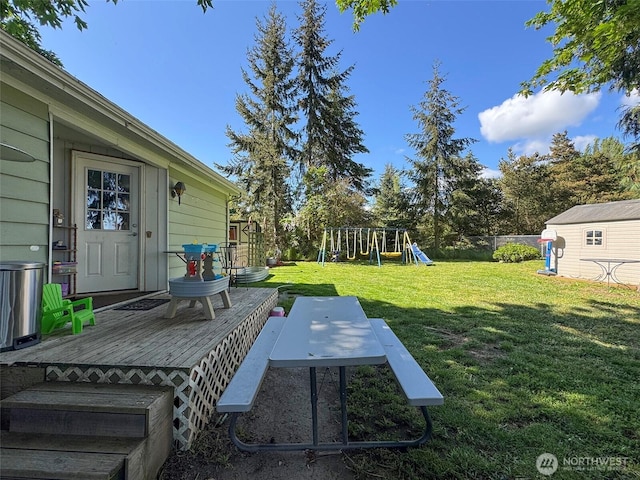 81 Robbins Rd, Sequim, WA 98382 - view of yard with a wooden deck, a playground, and an outdoor structure