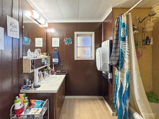 81 Robbins Rd, Sequim, WA 98382 - full bathroom featuring wood finished floors, a shower with curtain, vanity, crown molding, and a textured ceiling