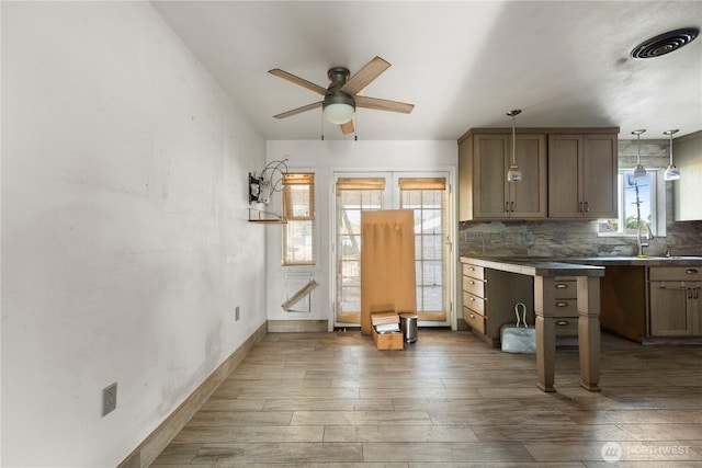 1203 S 8th Ave, Yakima, WA 98902 - kitchen featuring ceiling fan, hardwood / wood-style flooring, decorative backsplash, and hanging light fixtures