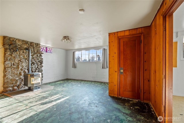 1203 S 8th Ave, Yakima, WA 98902 - unfurnished living room with a wood stove and concrete floors